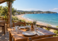 Restaurant terrace overlooking a sandy beach and blue sea