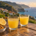 Two glasses of lemon poncha overlooking a coastal bay
